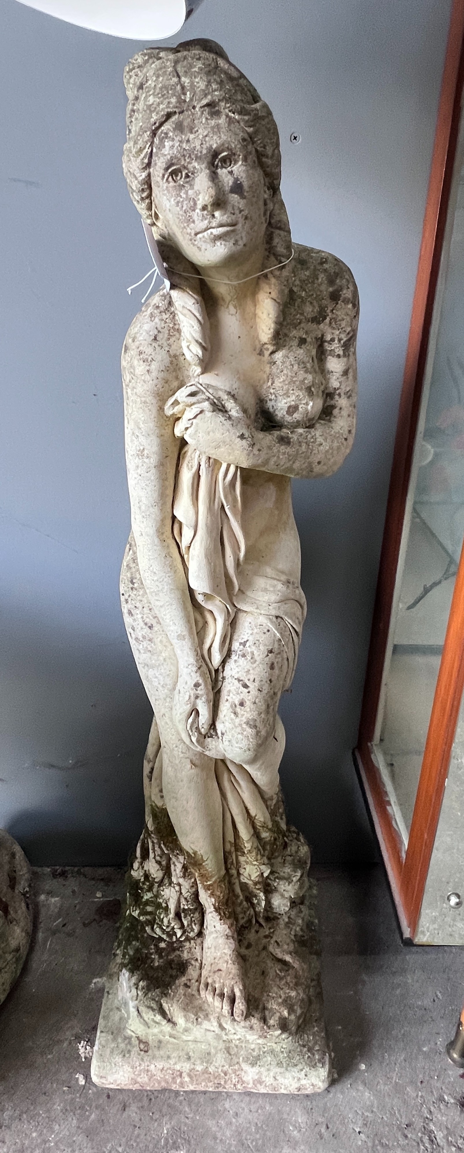 A reconstituted stone garden statue of a female bather, height 95cm